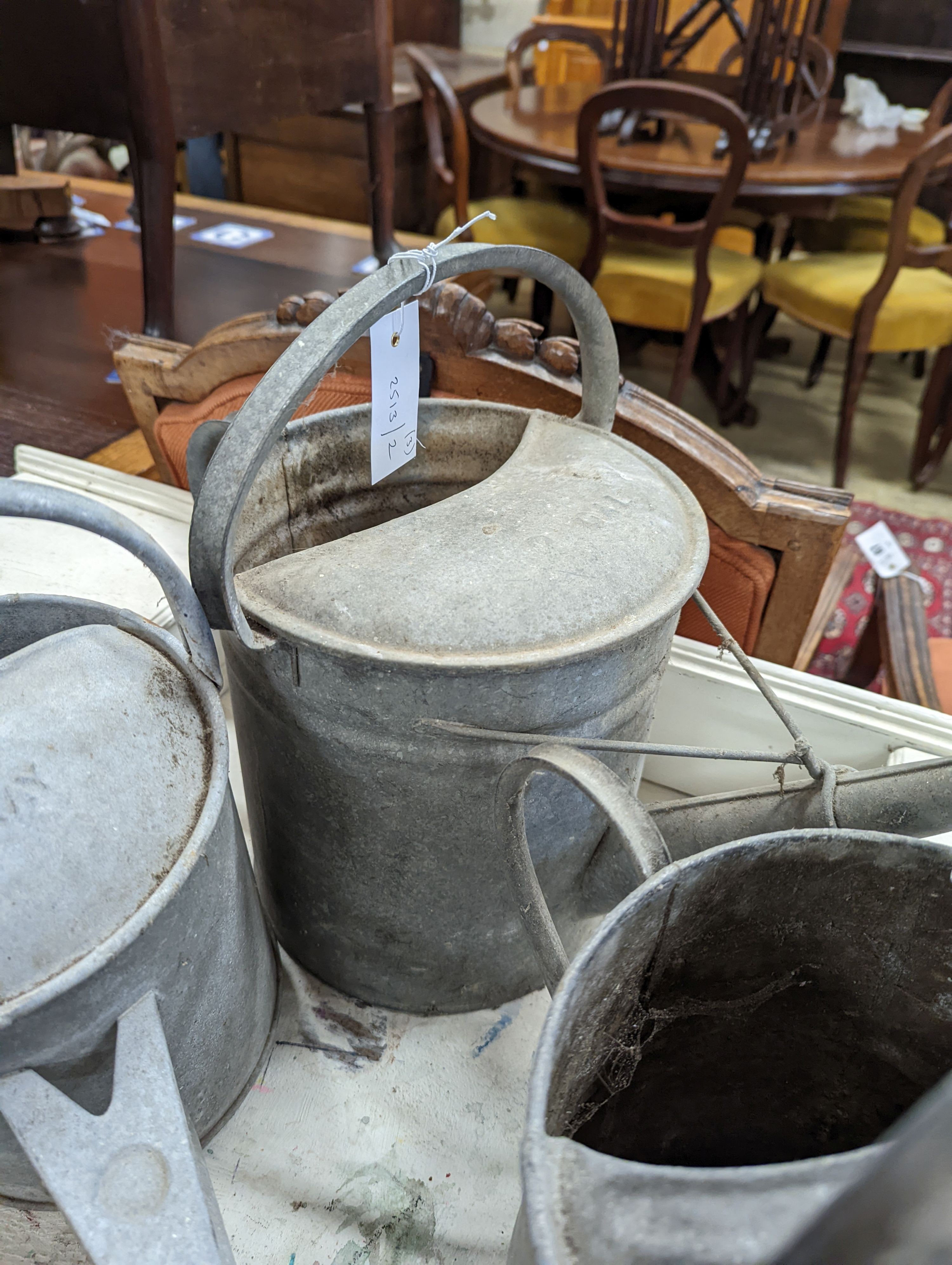 Three vintage galvanized watering cans